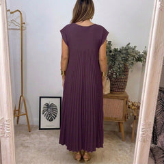 Abito lungo viola scuro senza maniche, schiena piena con pieghe verticali.