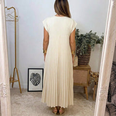 Abito lungo beige con schiena scoperta e pieghe verticali