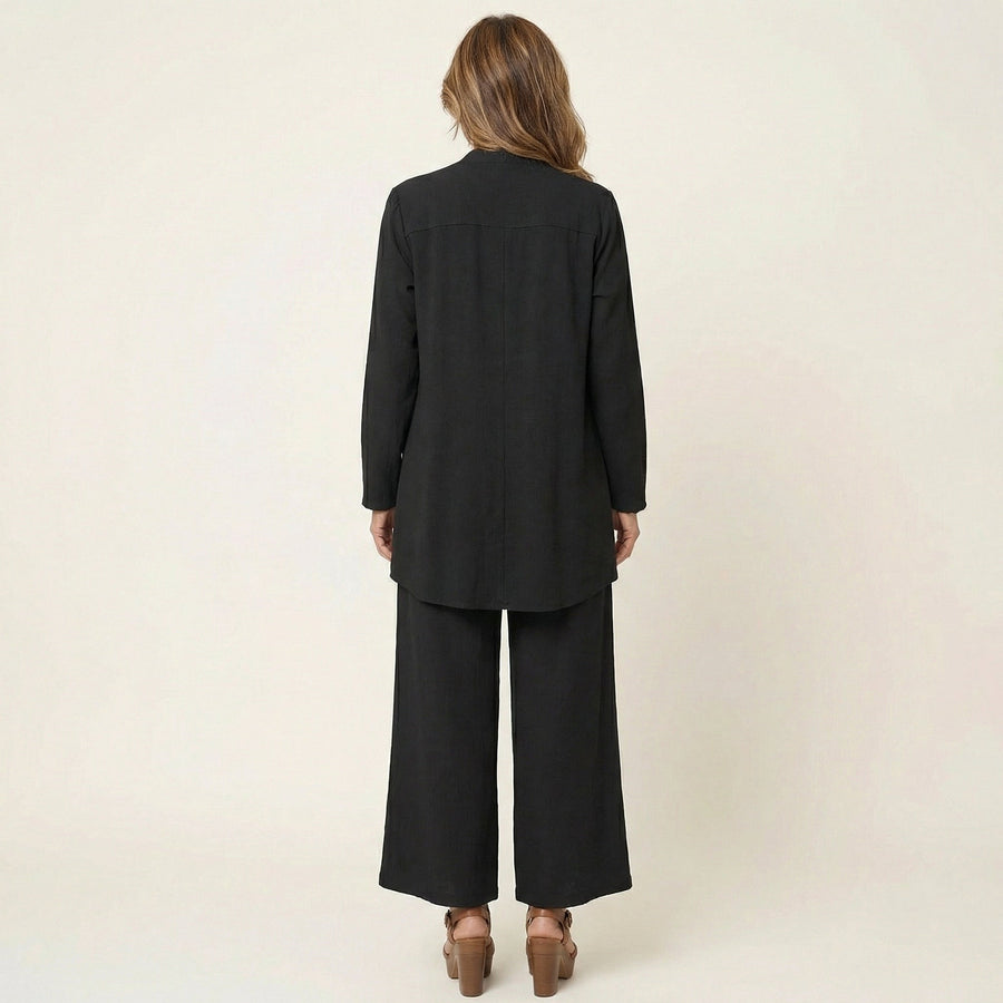 Black three-piece set, back view: tunic, long jacket, and wide-leg pants