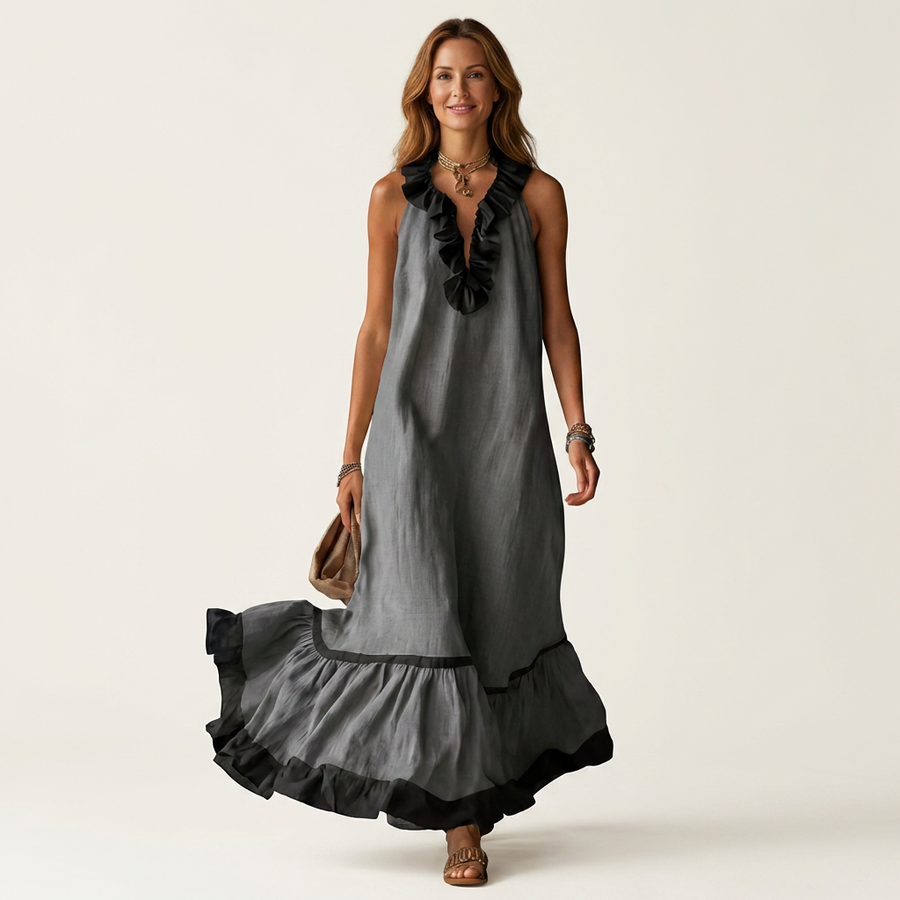 Sleeveless dark gray maxi dress with black ruffle neckline and tiered skirt hem trim, front view