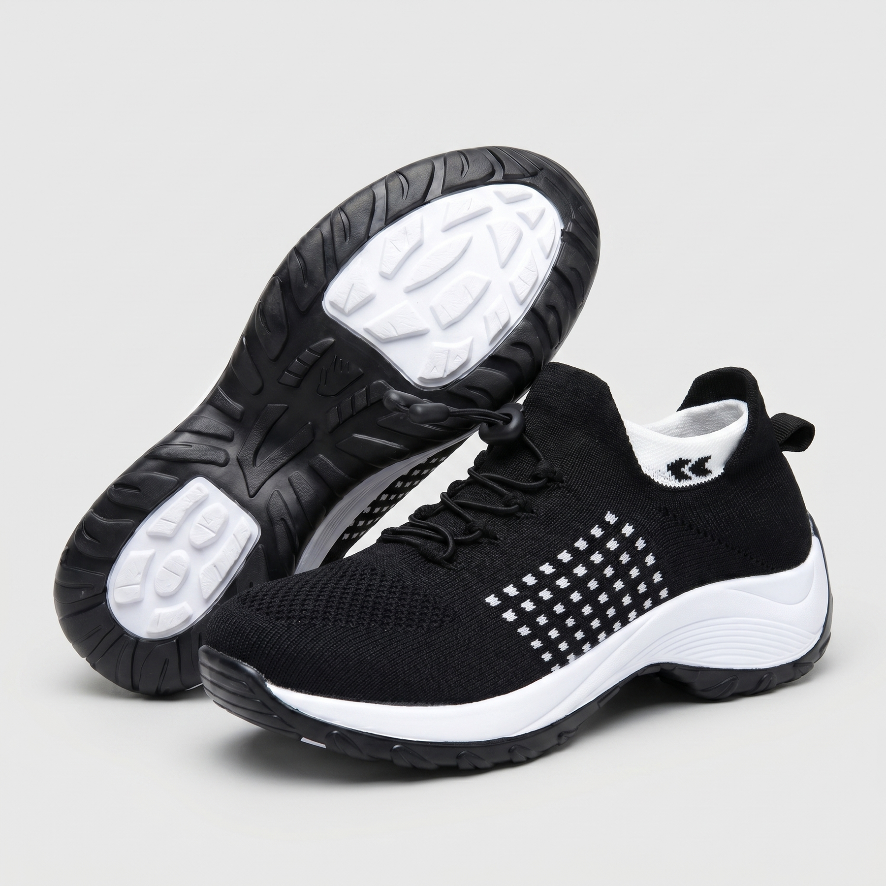 Scarpe comfort ortopediche nere con inserti a griglia bianca e suola chiara con profilo