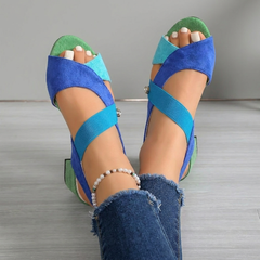 Back view of blue suede block-heel sandals with ankle strap and bead bracelet