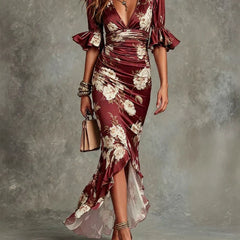 Abito lungo bordeaux con stampa floreale, scollo a V e maniche a sbuffo, gonna con balze