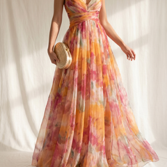 Abito maxi floreale multicolor con corsetto annodato e bretelle sottili, gonna ampia.