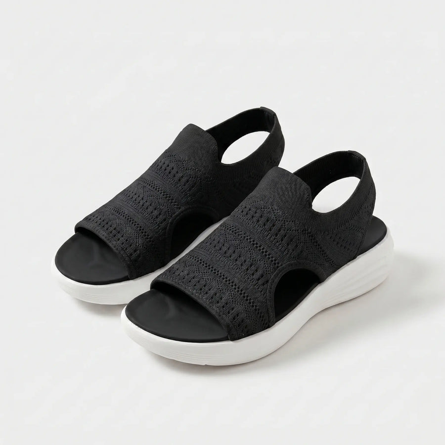 Sandali comfort neri con tomaia in maglia traforata e suola bianca
