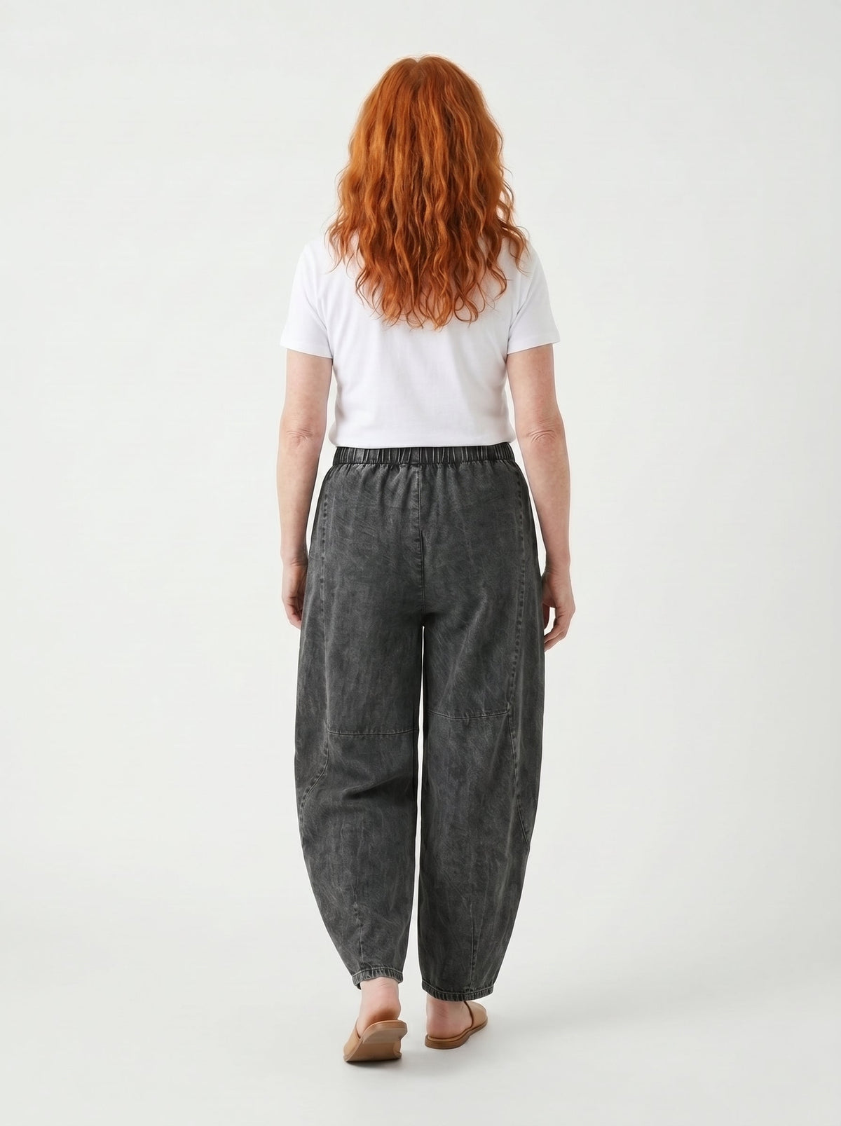 Dark grey relaxed elastic-waist denim trousers, back view with wide straight legs