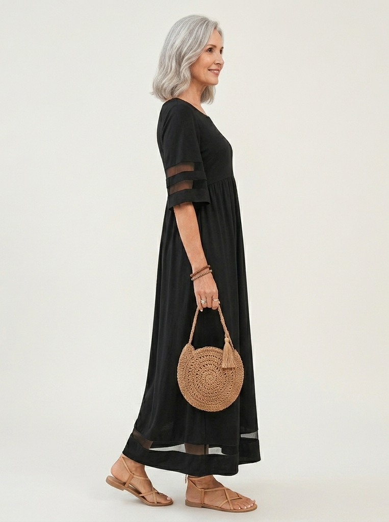 Black midi dress, side view, gathered waist, sheer stripe sleeves, and sheer hem panel