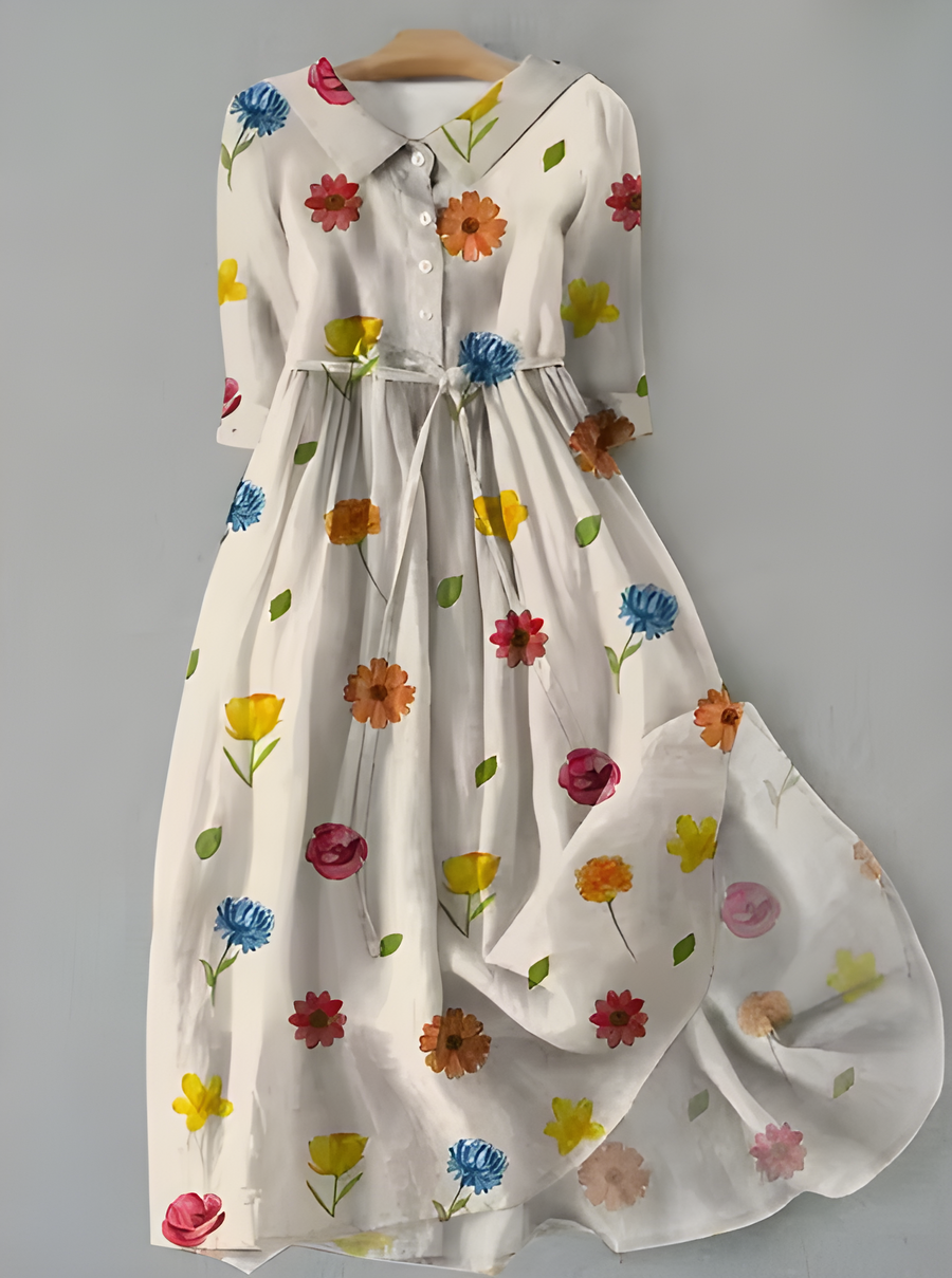 White floral button-up dress with long sleeves and tied waist