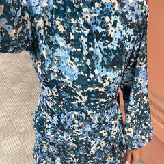 Blue floral long-sleeve dress close-up with high neck and gathered waist detail