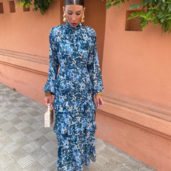 Blue floral midi dress with high neckline, long sleeves, and tiered ruffle hem