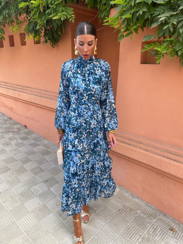 Blue floral midi dress with high neck, long sleeves, and layered tiered skirt