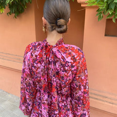 Floral midi dress back view with ruffled high neck and long puff sleeves