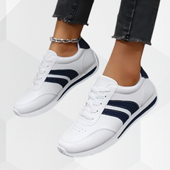 Scarpe bianche con dettagli blu e lacci; suola con bordo scuro, naso rotondo