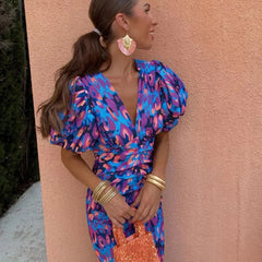 Blue/pink animal-print puff-sleeve V-neck midi dress with tied waist, side view, sequin mini bag