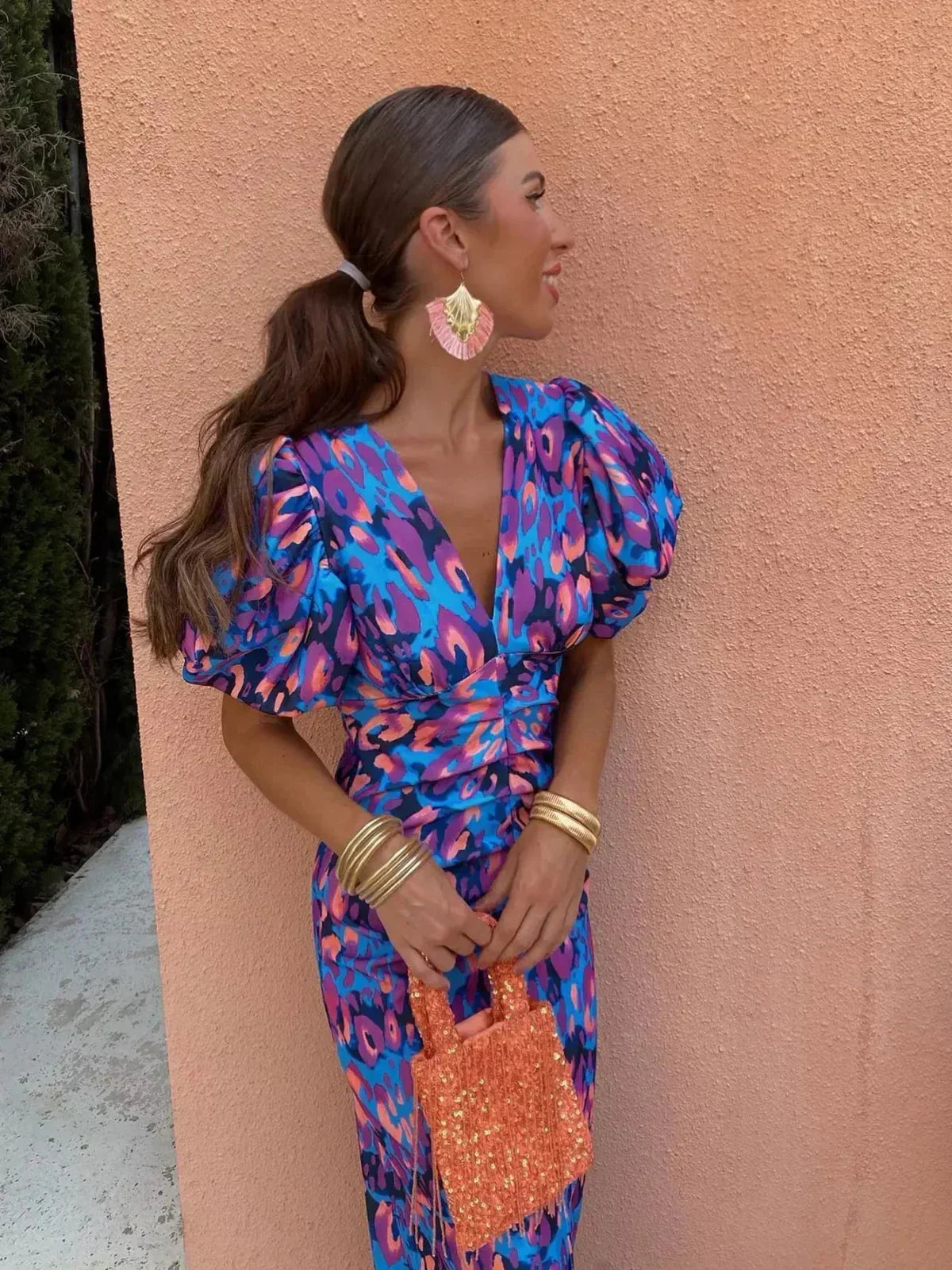 Blue/pink animal-print puff-sleeve V-neck midi dress with tied waist, side view, sequin mini bag