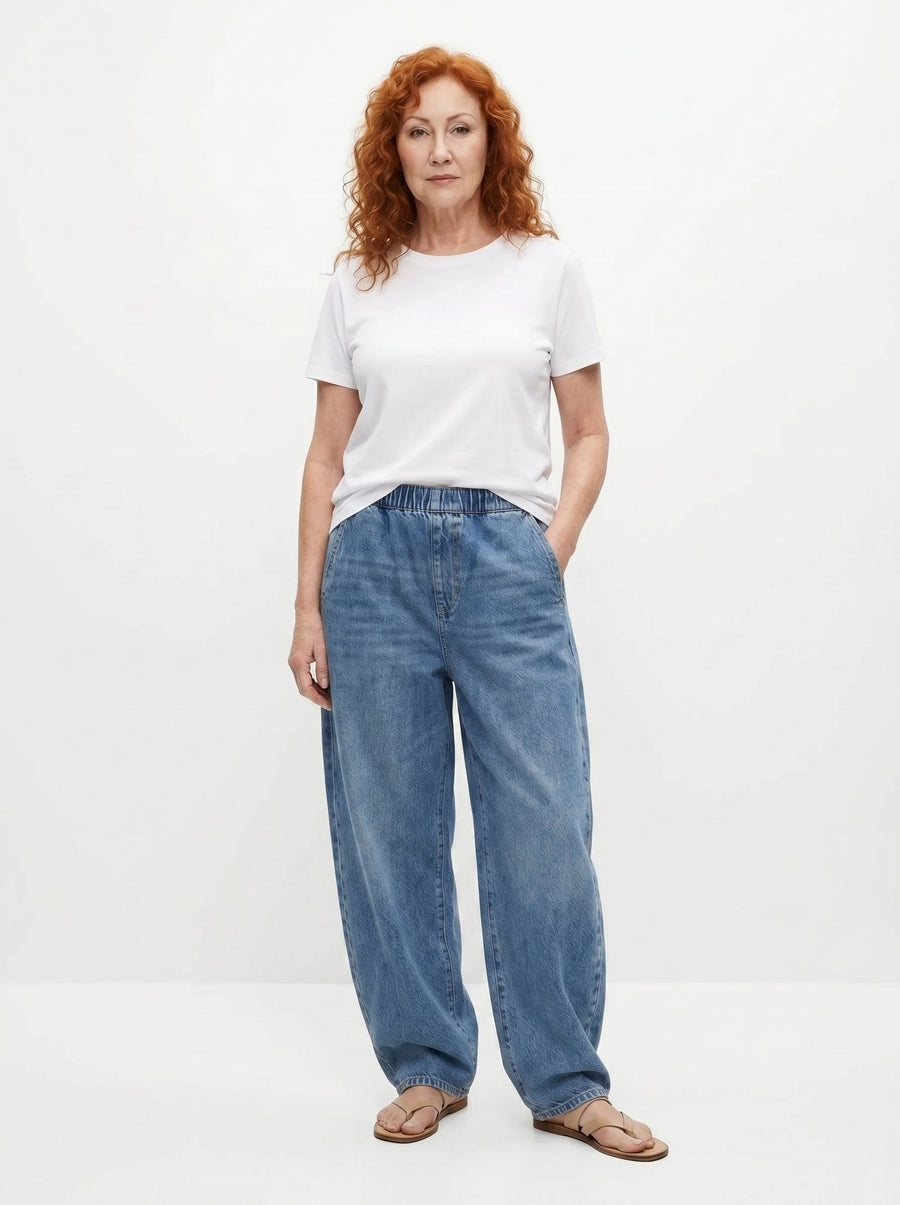 Blue relaxed elastic-waist denim trousers with wide legs and visible front seams