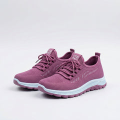 Sneakers urbane rosa traspiranti con lacci e suola bianca, vista laterale