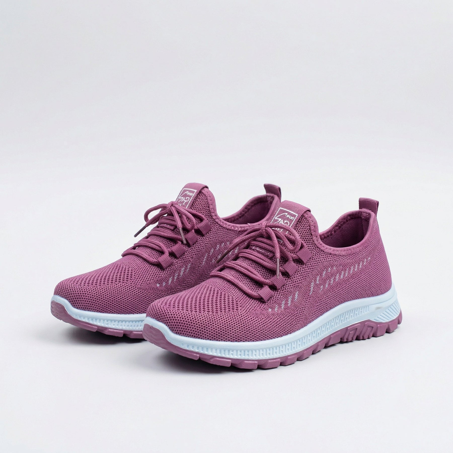 Sneakers urbane rosa traspiranti con lacci e suola bianca, vista laterale