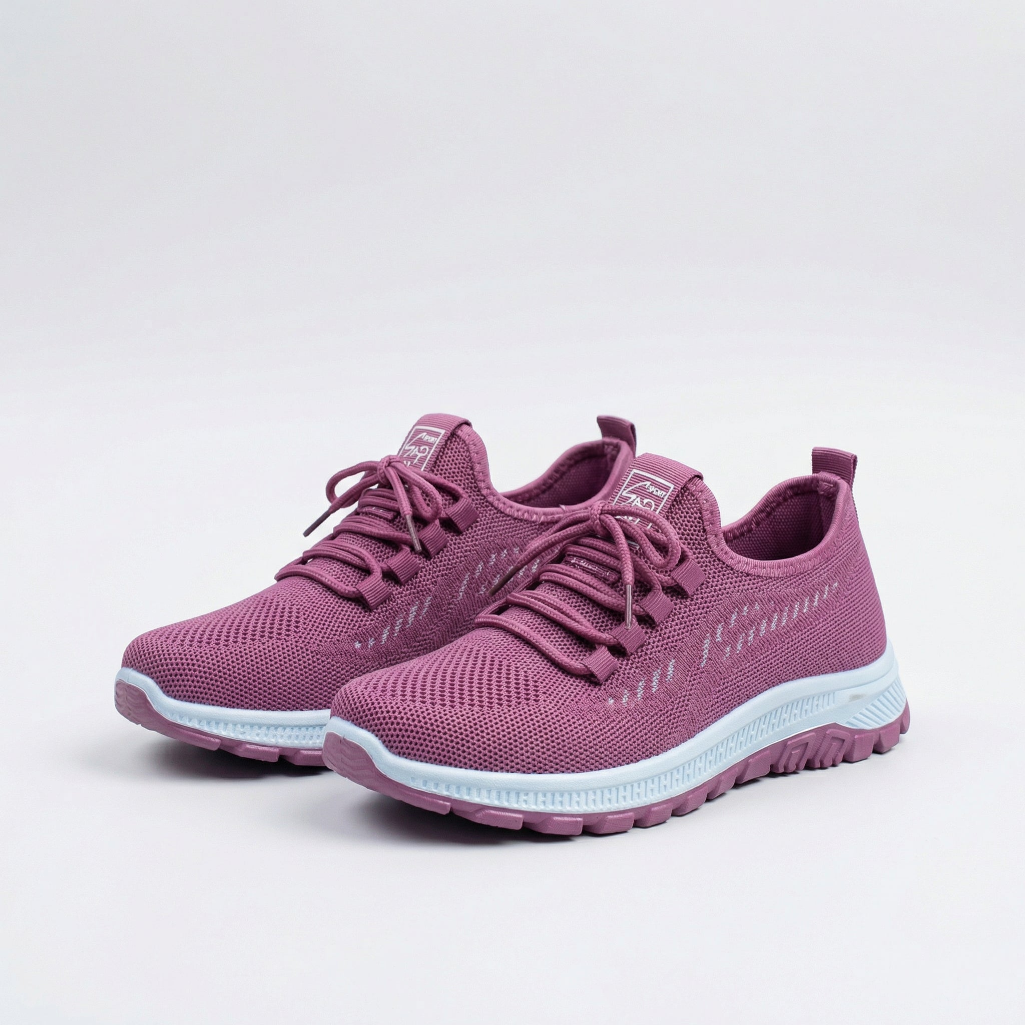 Sneakers urbane rosa traspiranti con lacci e suola bianca, vista laterale