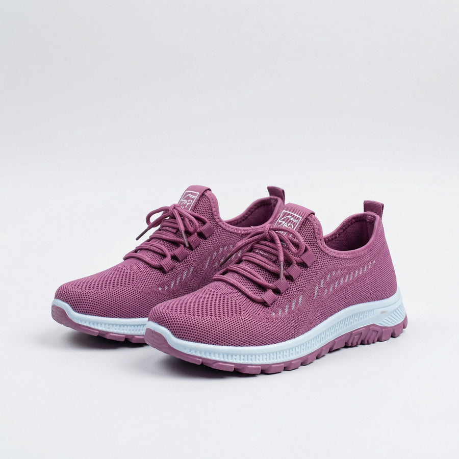 Sneakers urbane rosa traspiranti con lacci e suola bianca, vista laterale