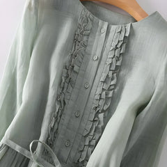 Sage green Amara vintage dress close-up: ruffled button-front bodice and tied waist detail