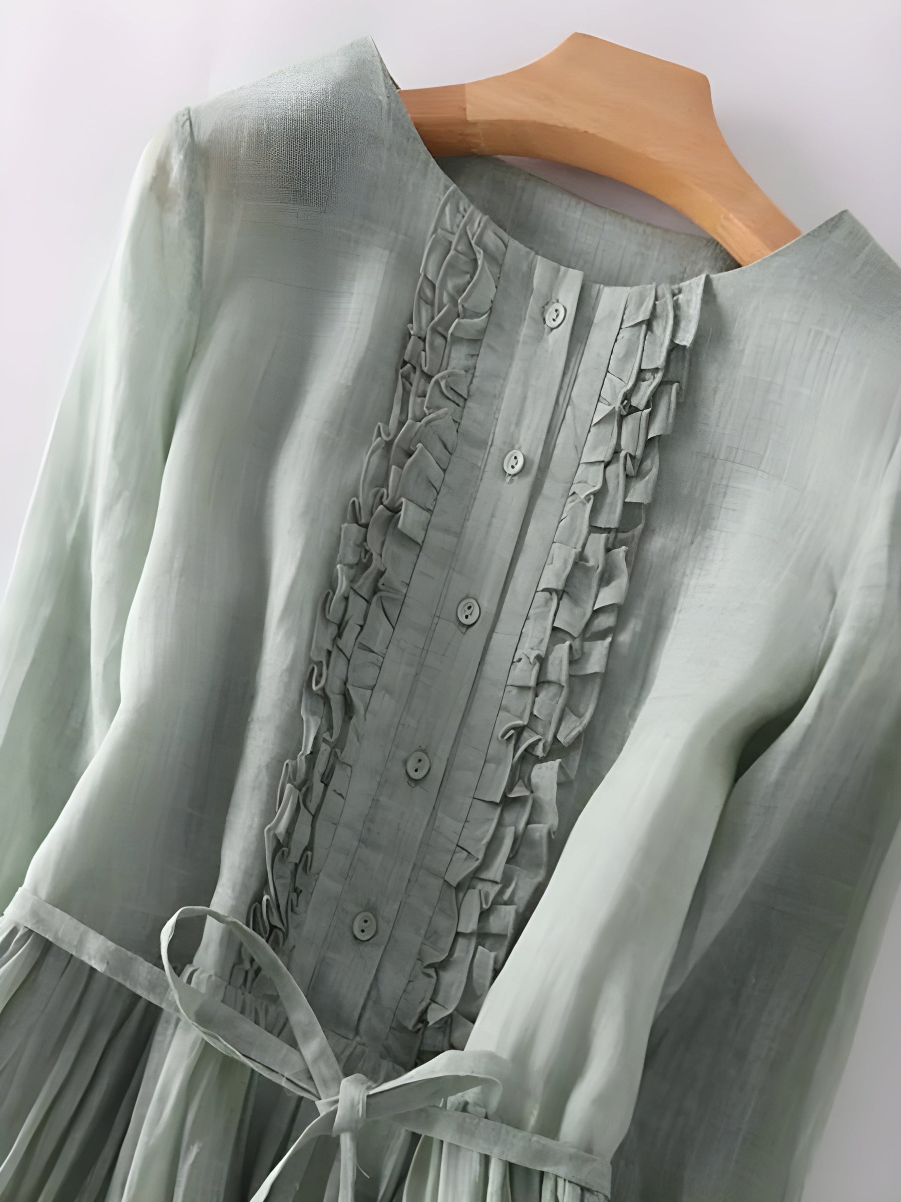 Sage green Amara vintage dress close-up: ruffled button-front bodice and tied waist detail