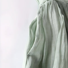 Sage green Amara vintage dress close-up: gathered skirt with tied waist and soft drape