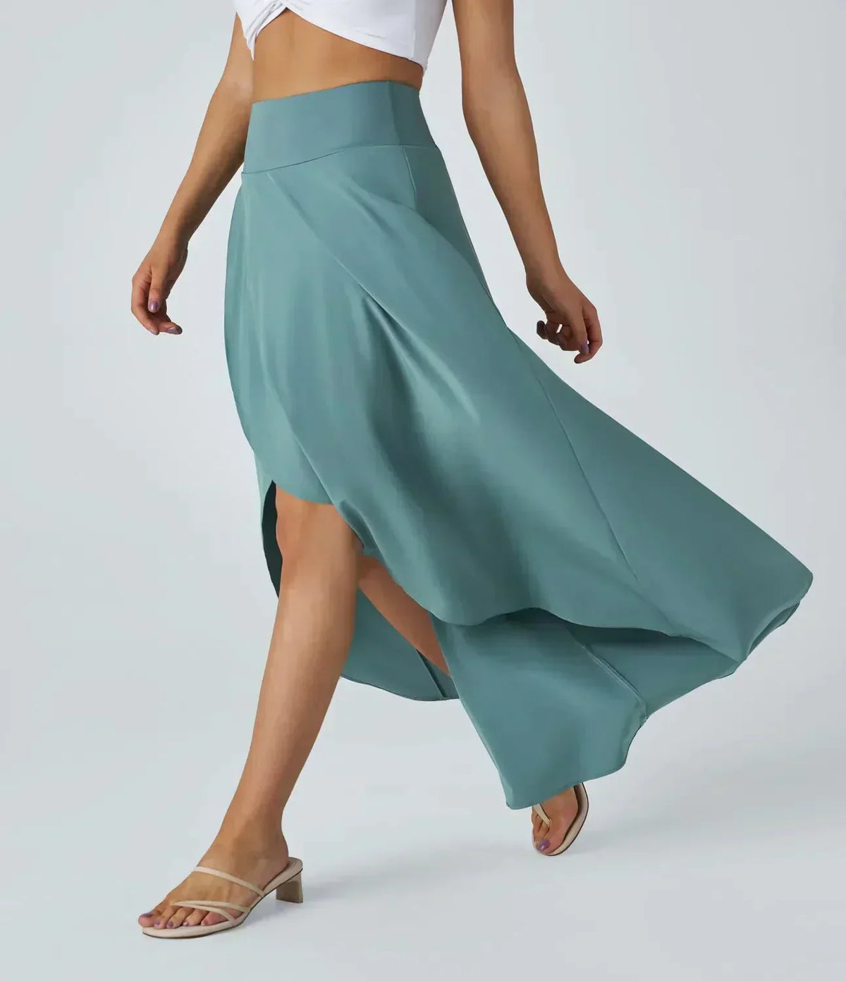 Teal-blue midi skirt with side-swept slit and flowing asymmetric hem