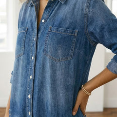 Washed blue denim button-through dress close-up with chest pockets and collar
