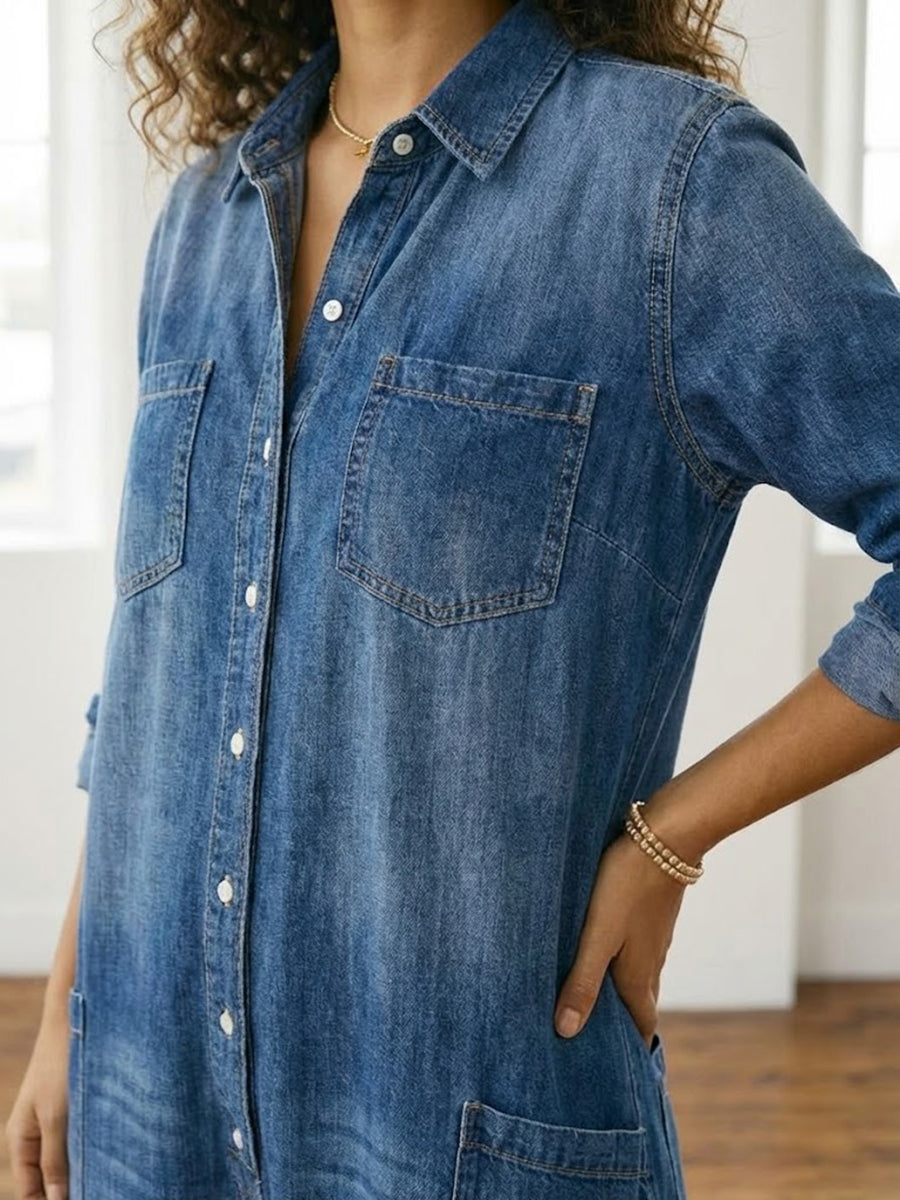 Washed blue denim button-through dress close-up with chest pockets and collar