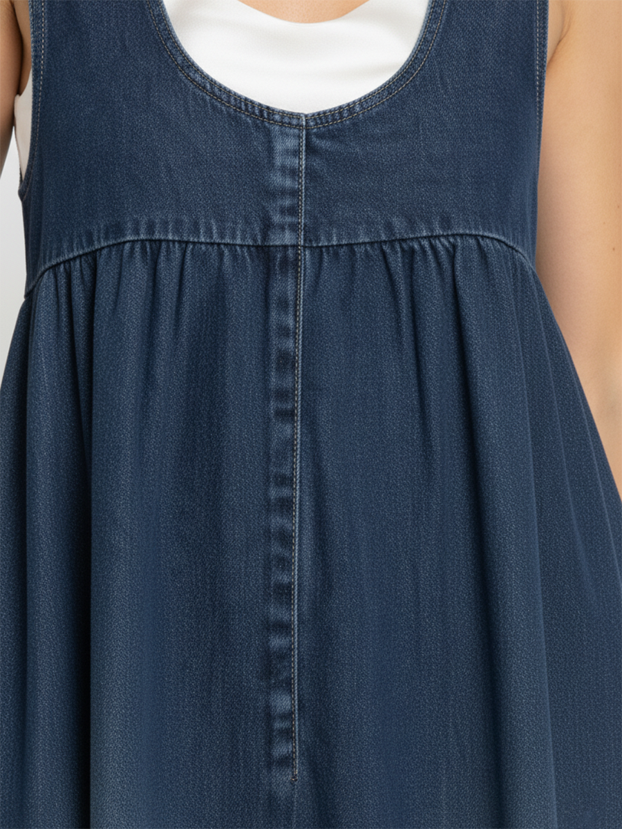 Blue denim sleeveless yoke with topstitching and gathered skirt section
