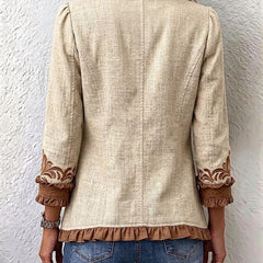 Tan linen jacket with brown ruffled cuffs and embroidered hem detail