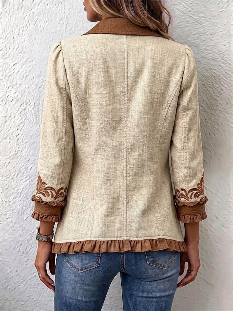 Tan linen jacket with brown ruffled cuffs and embroidered hem detail