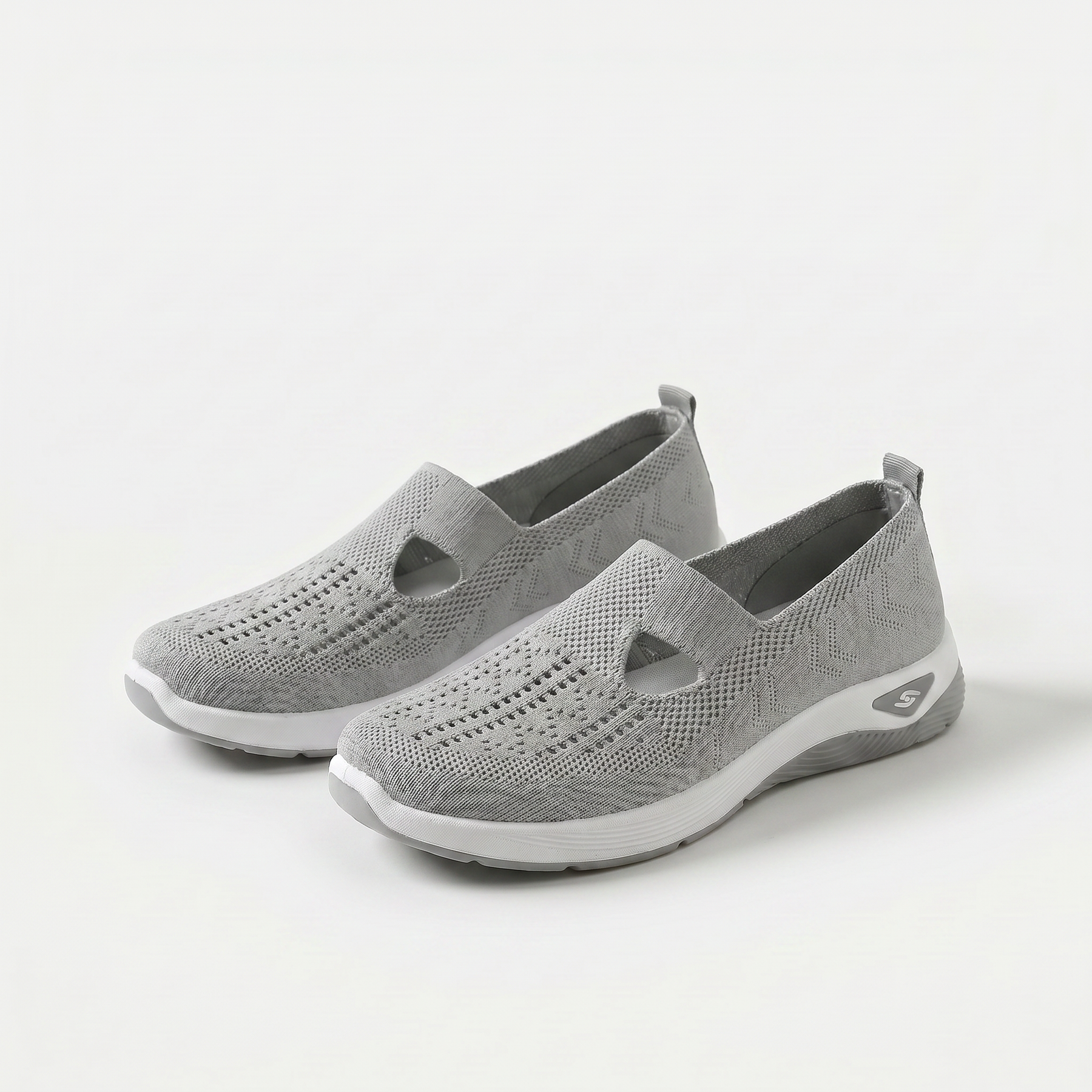 Scarpe ortopediche ammortizzanti slip-on grigie in maglia traforata con suola bianca