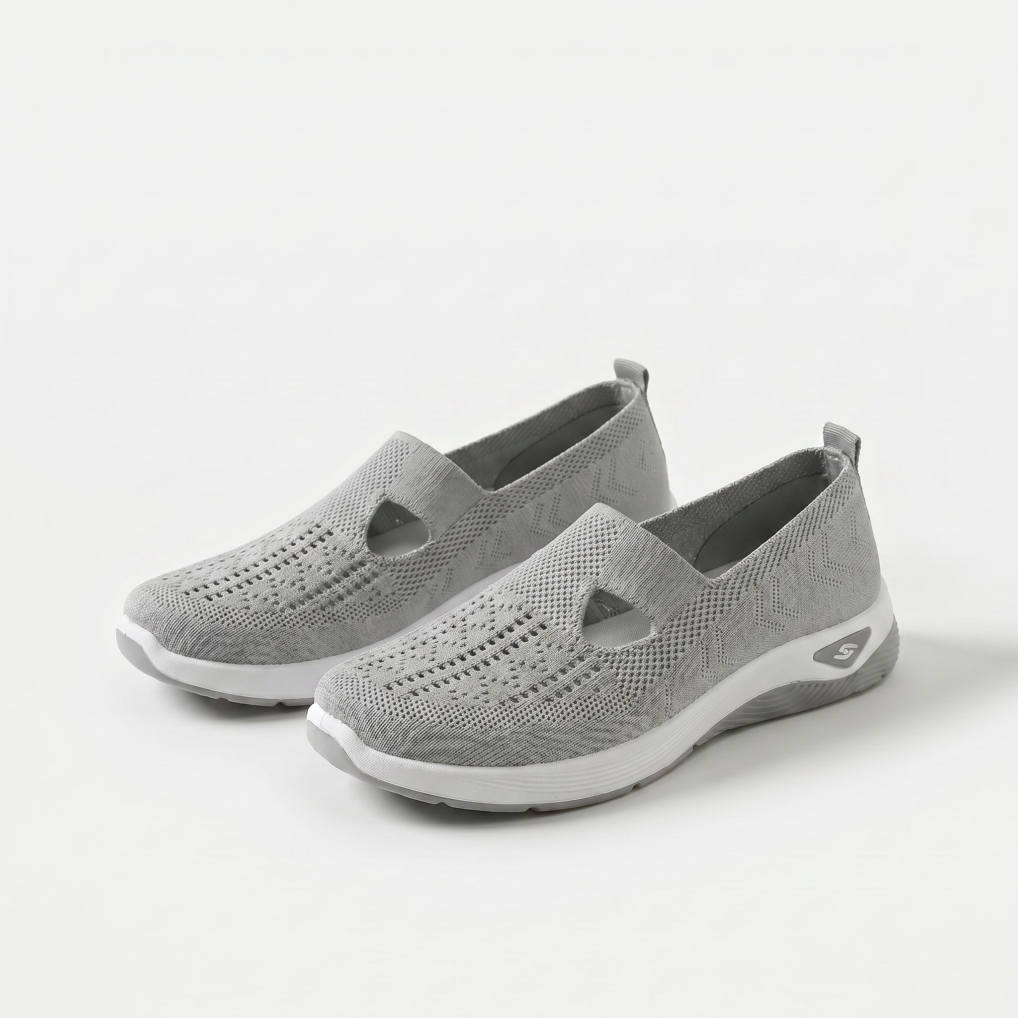 Scarpe ortopediche ammortizzanti slip-on grigie in maglia traforata con suola bianca