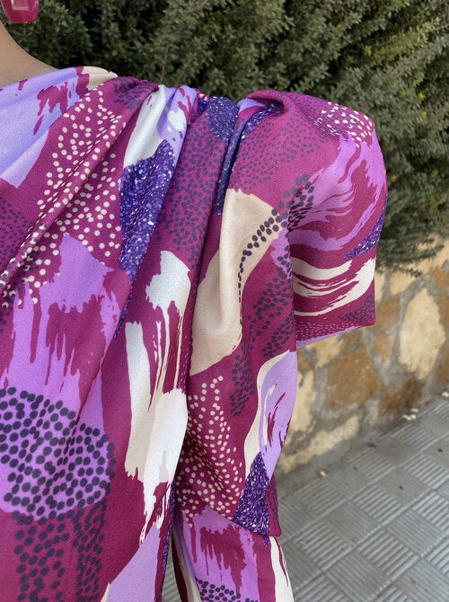 Yllana one-shoulder dress close-up, draped sleeve with purple and white abstract print