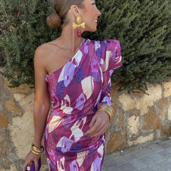Yllana one-shoulder dress, side view with gathered drape and purple-pink abstract print