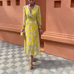 Yellow V-neck midi dress with purple floral print, long sleeves, wrap waist