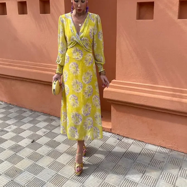 Yellow V-neck midi dress with purple floral print, long sleeves, wrap waist