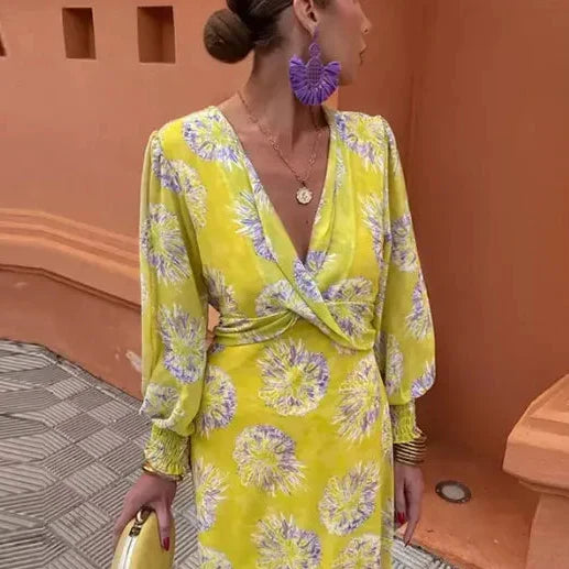 Yellow wrap midi dress with V-neck, long puff sleeves, and purple floral print