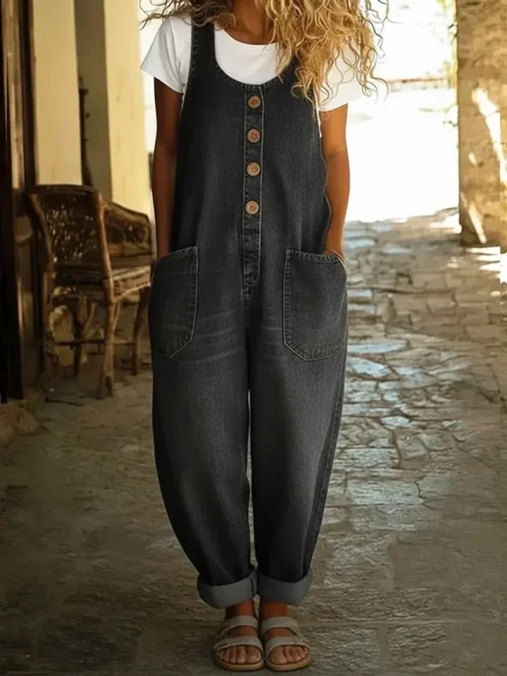 Black denim overalls with button front, chest pocket, and relaxed wide-leg silhouette