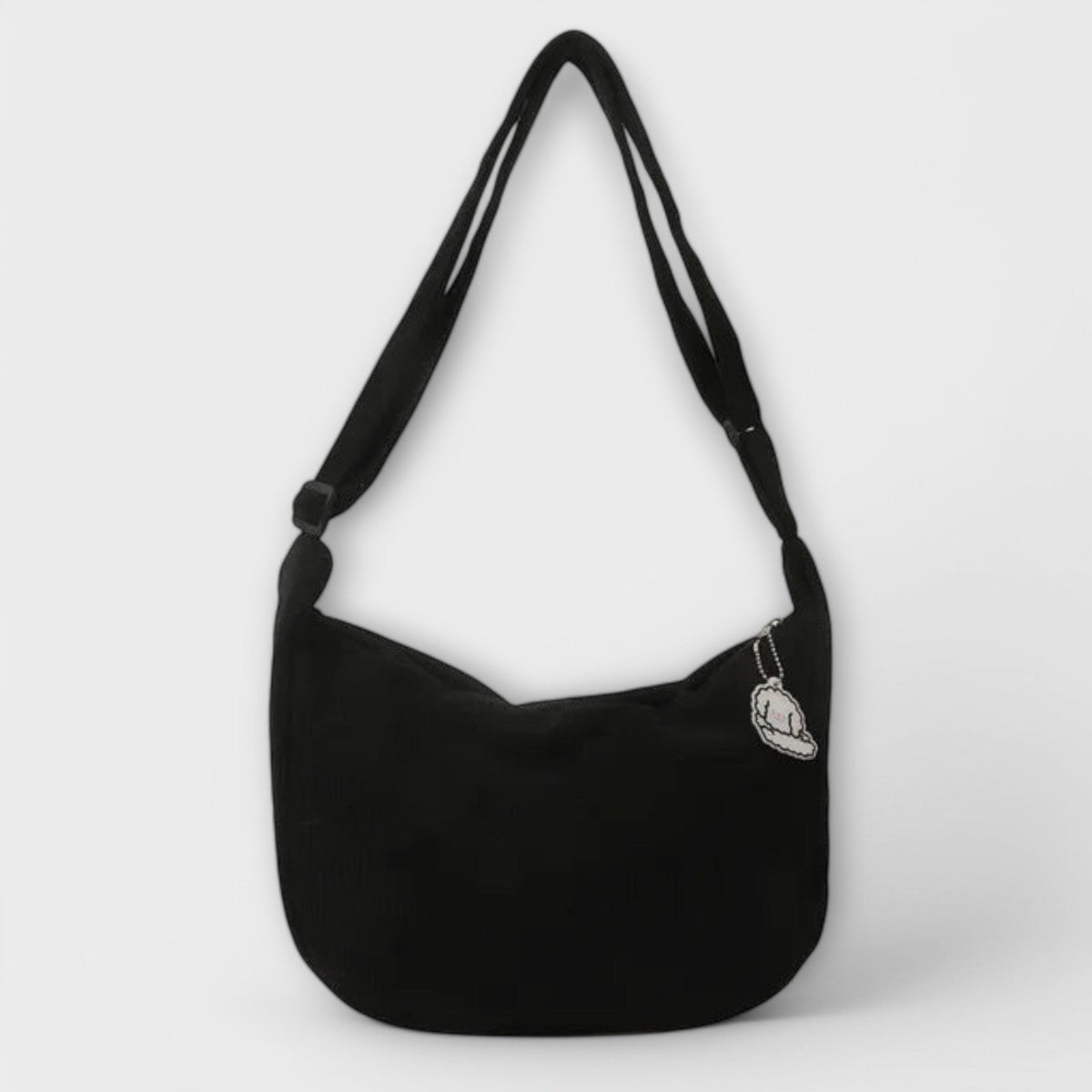 Alexa women’s shoulder bag, black corduroy hobo shape with cloud charm patch