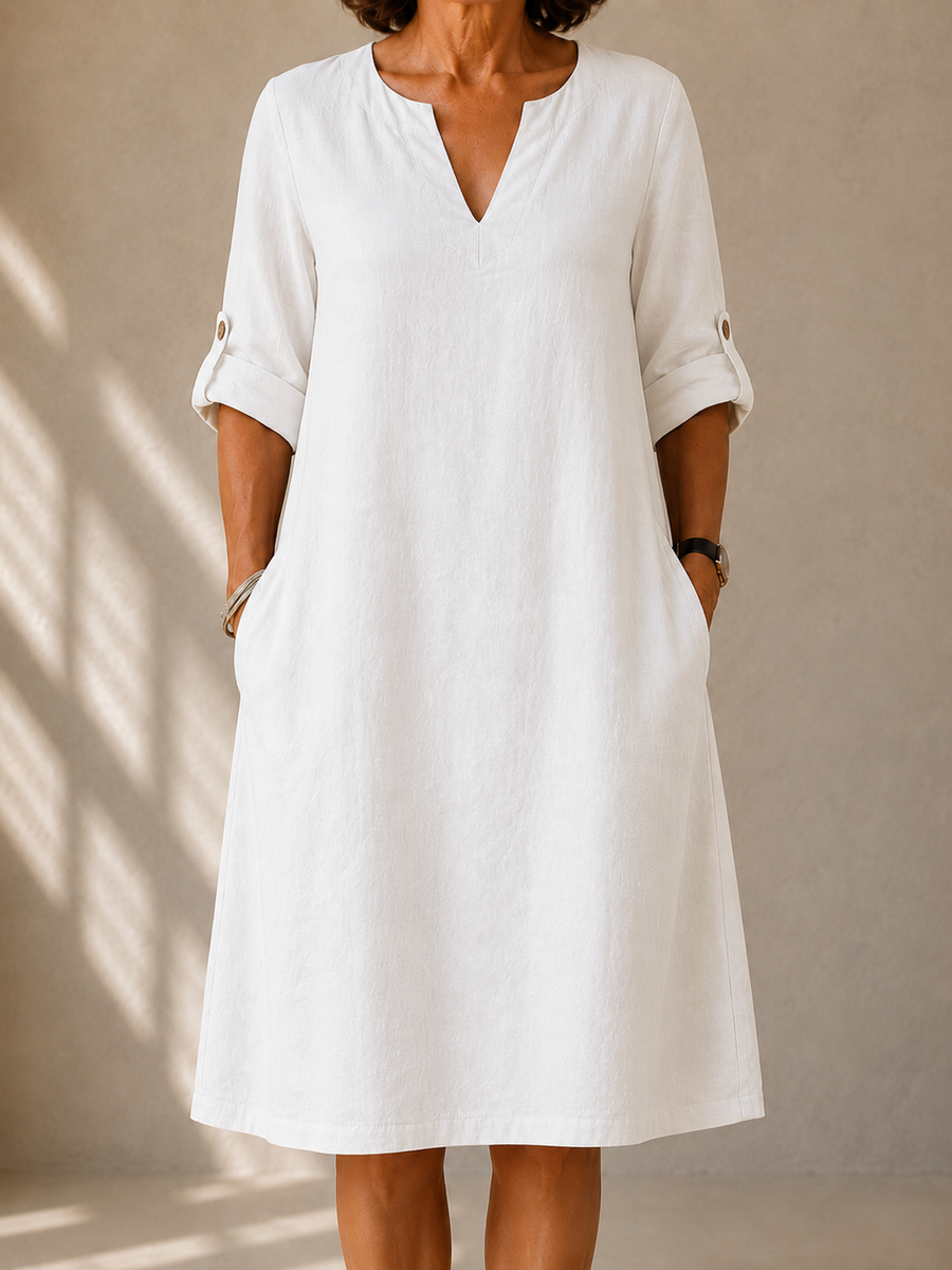 White classic V-neck midi dress with three-quarter sleeves and side pockets